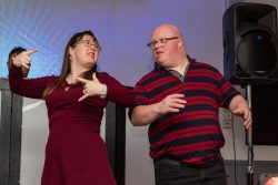 A lady and a man dancing together.