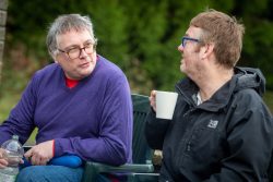 Two met outside, drinking tea and having a chat Two met outside, drinking tea and having a chat