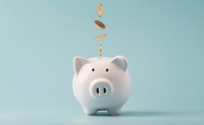 Coins falling to white piggy saving , Financial and money depos